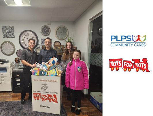 PLPS team behind a box of toys for tots